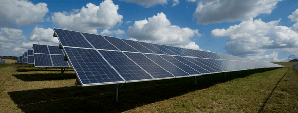 A line of solar panels in an open field