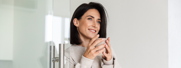 Woman holding hot drink staying warm at supported living