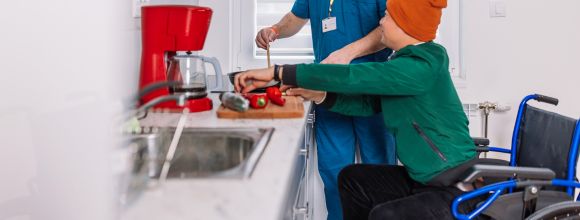 vulnerable person being helped by carer