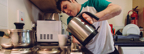 vulnerable man alone holding a kettle