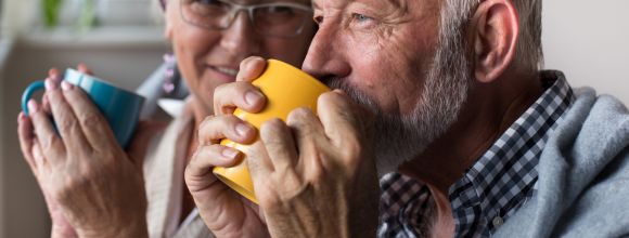 elderly people at home drinking tea
