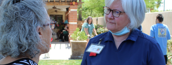 Member of the Falcon HA having a conversation with a lady at our celebration of good care month, honouring the heart of the community
