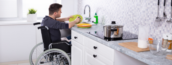 man in a wheelchair benefiting from supported living circumstances