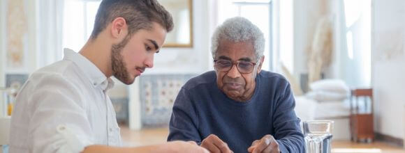 Two people sat together, one in supported living